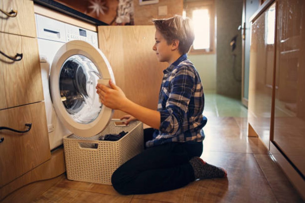 Little boy is unloading a washing machine. 
Shot with Canon R5