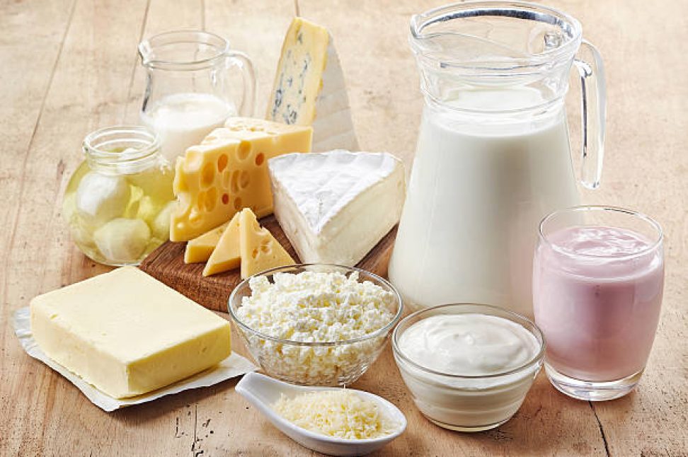 Various fresh dairy products on wooden background